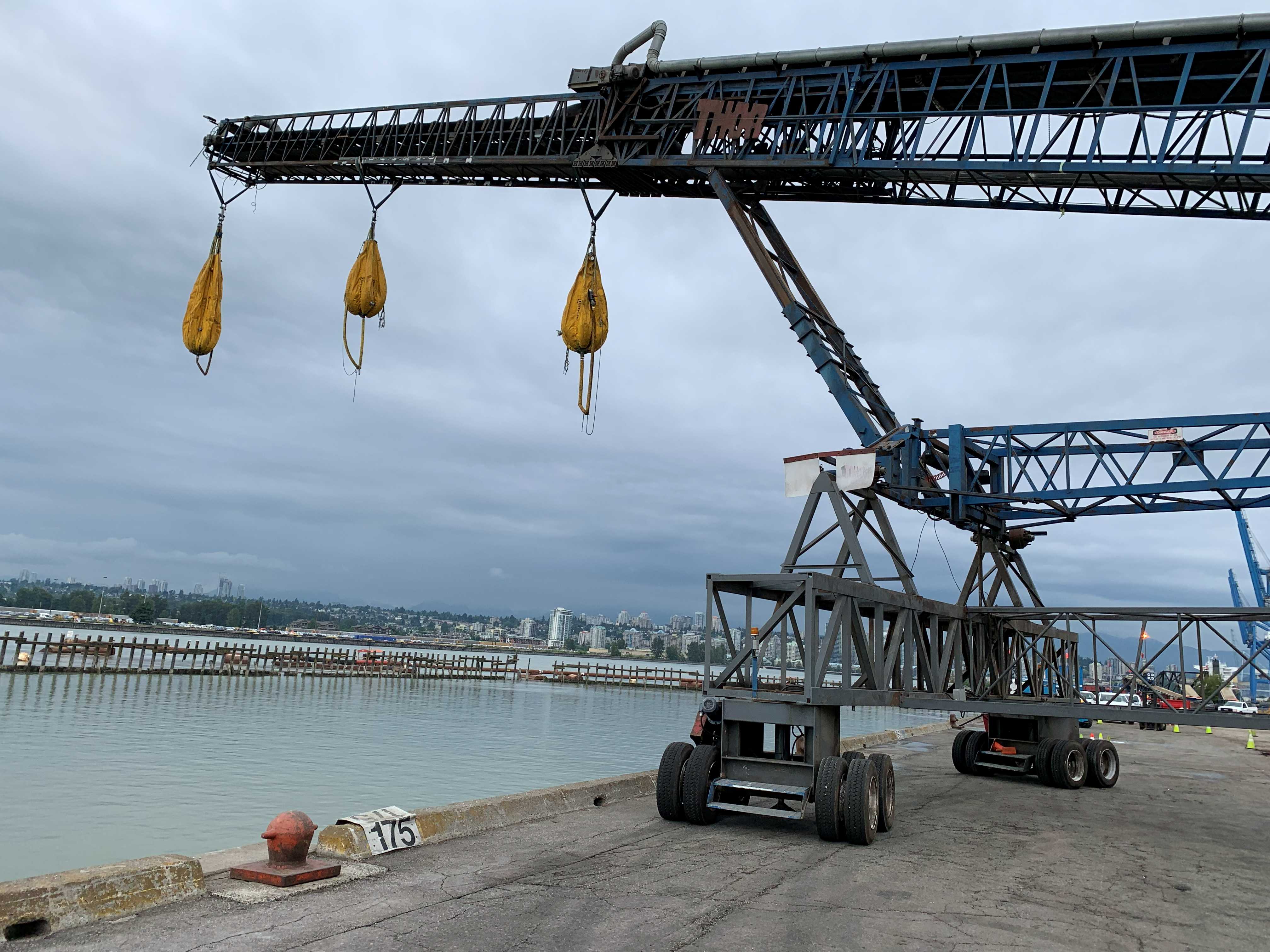Load testing with yellow sandbags on a marine crane at a Vancouver waterfront terminal